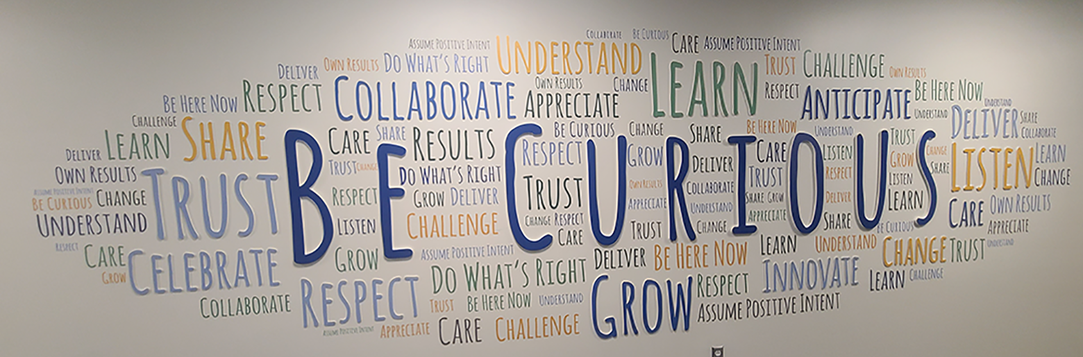 a sign that says Be Curious