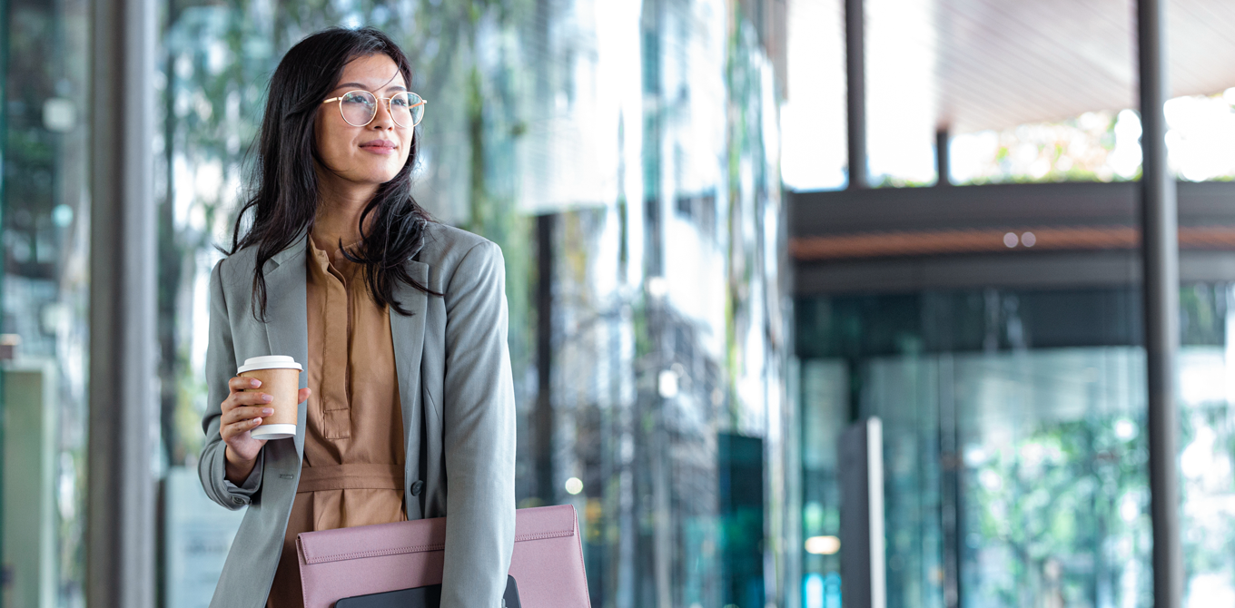 young woman walking with coffee