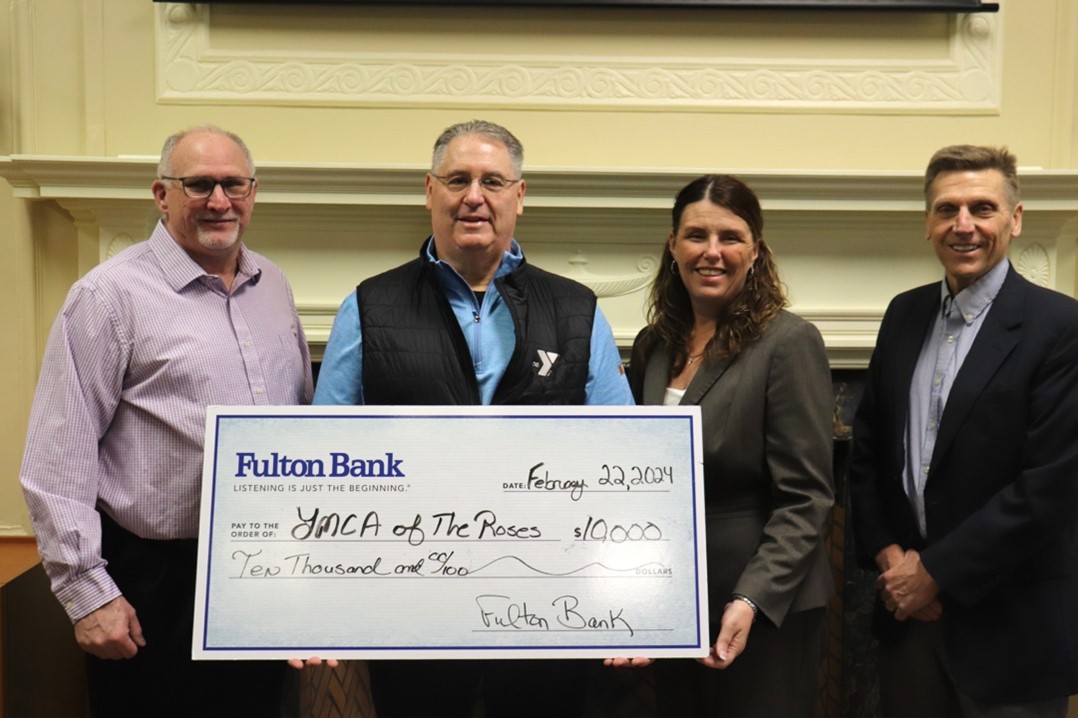 Members of the YMCA of the Roses receive a donation check from Fulton Bank